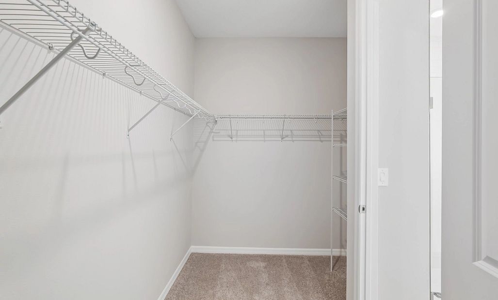 Spacious walk-in closet located off the primary bathroom