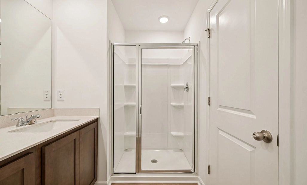 Primary Bath featuring the AW Collection® Roosevelt - Elegant tile and bold hardware finishes.