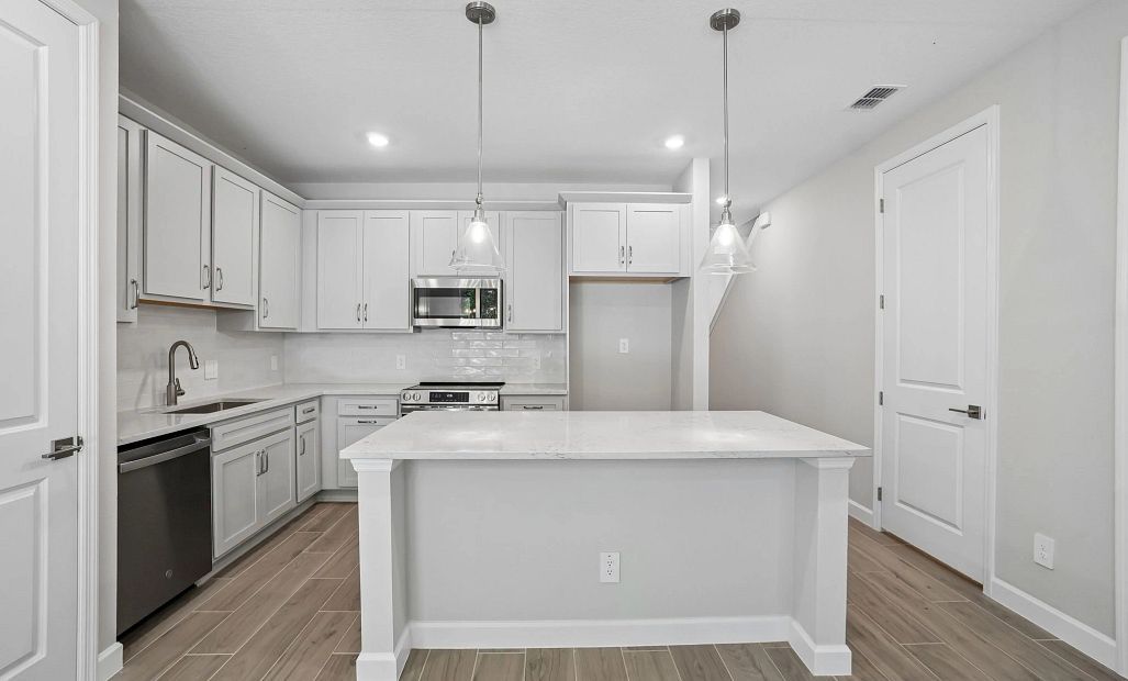Spacious kitchen centers the home featuring AW Collection® Milan - Representative images and