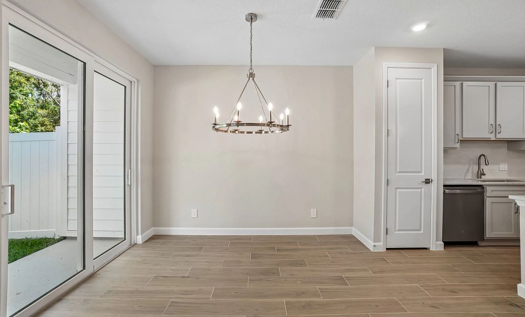 Dining space located off the kitchen and looking out to the covered back patio - Representative