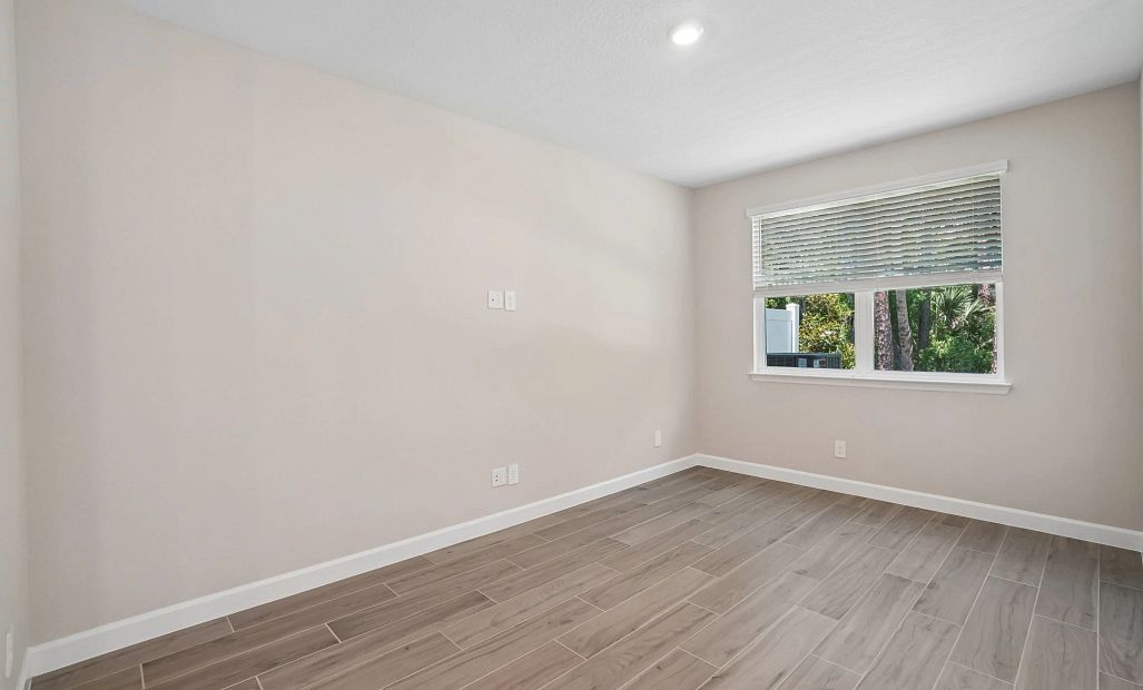 Family room space featuring a large double window - Representative images and renderings are for