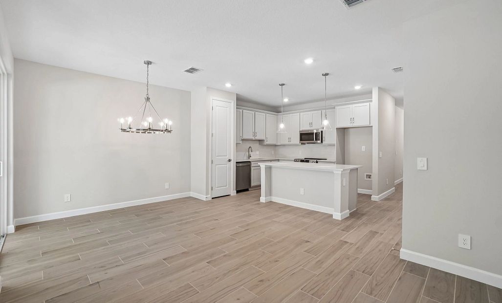 Family room and dining room open up into the kitchen - Representative images and renderings are for