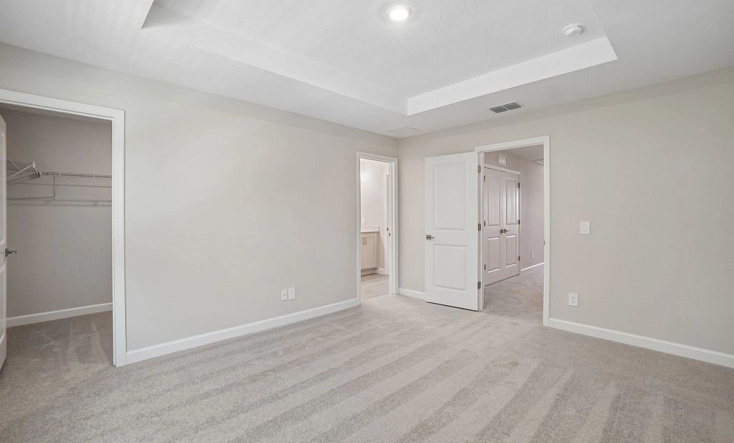 Primary bedroom features separate closet and bathroom - Representative images and renderings are for