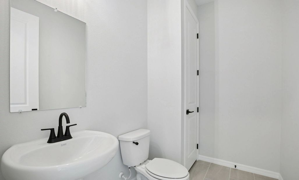 Powder bathroom located off the kitchen - Representative images and renderings are for illustrative
