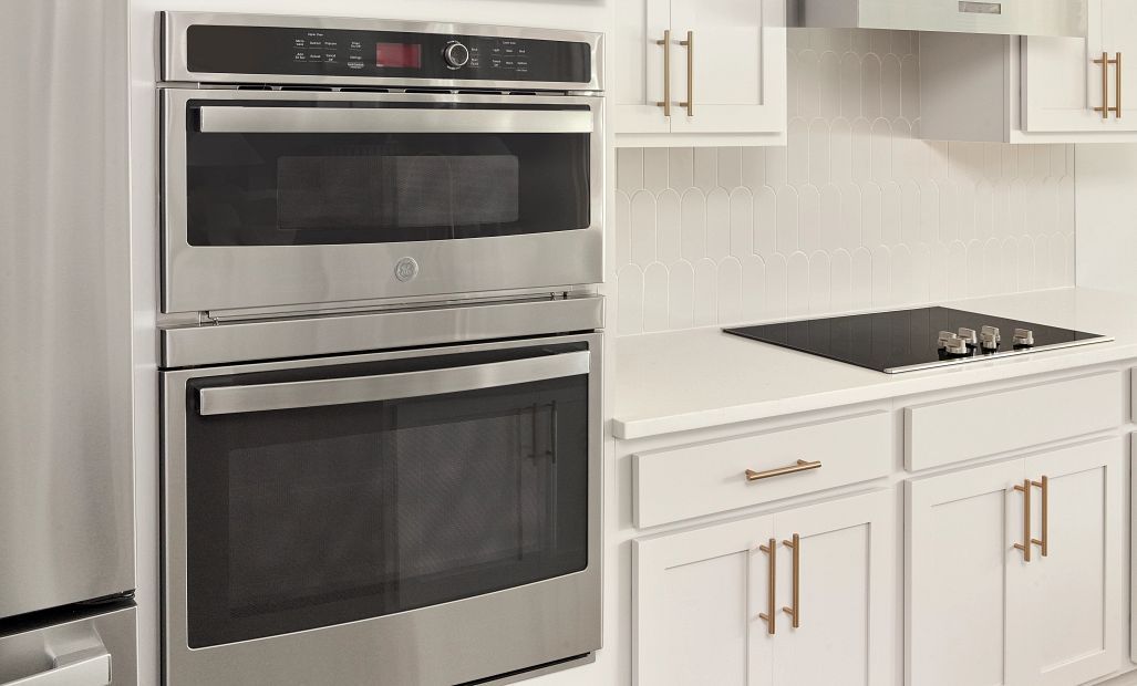Visual of the gourmet kitchen layout with the stacked oven and microwave and flat top range with