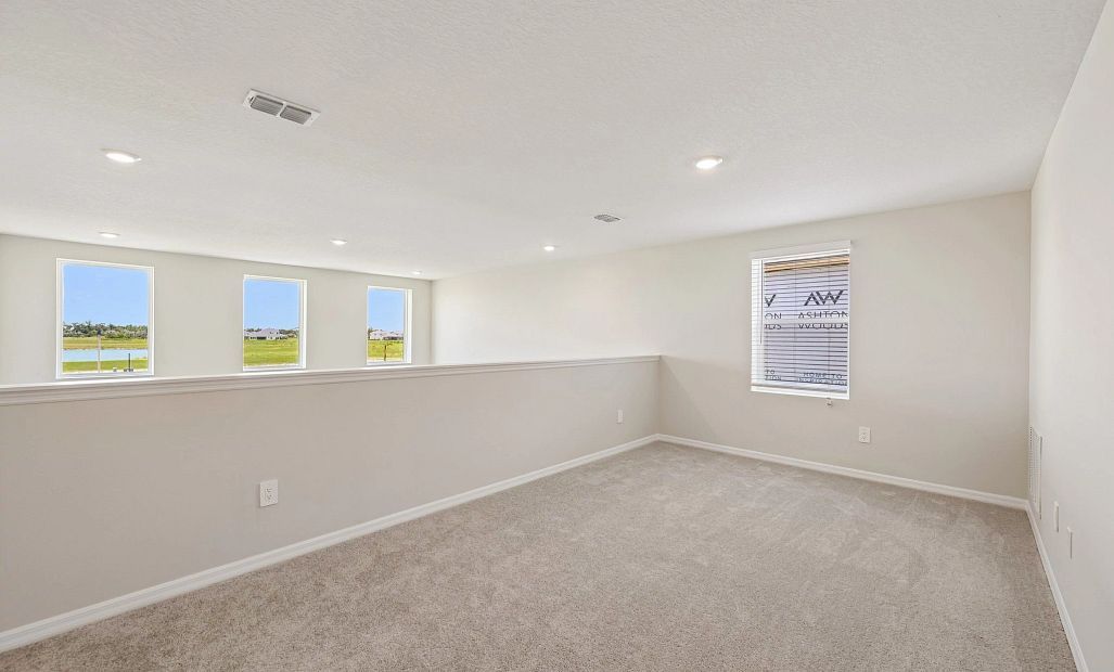 Upstairs loft looks out to the two-story great room - Representative images and renderings are for
