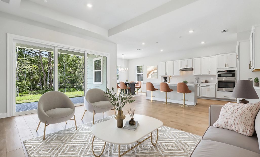 Virtually Staged family room that opens up into the kitchen and dining space