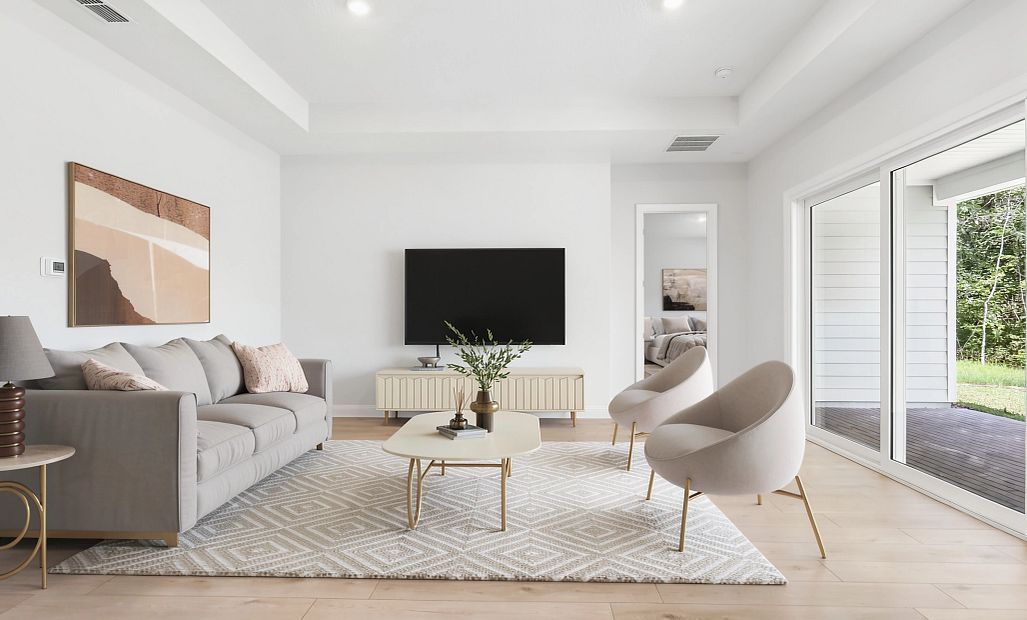 Virtually staged spacious family room space looks out through the oversized sliding glass doors