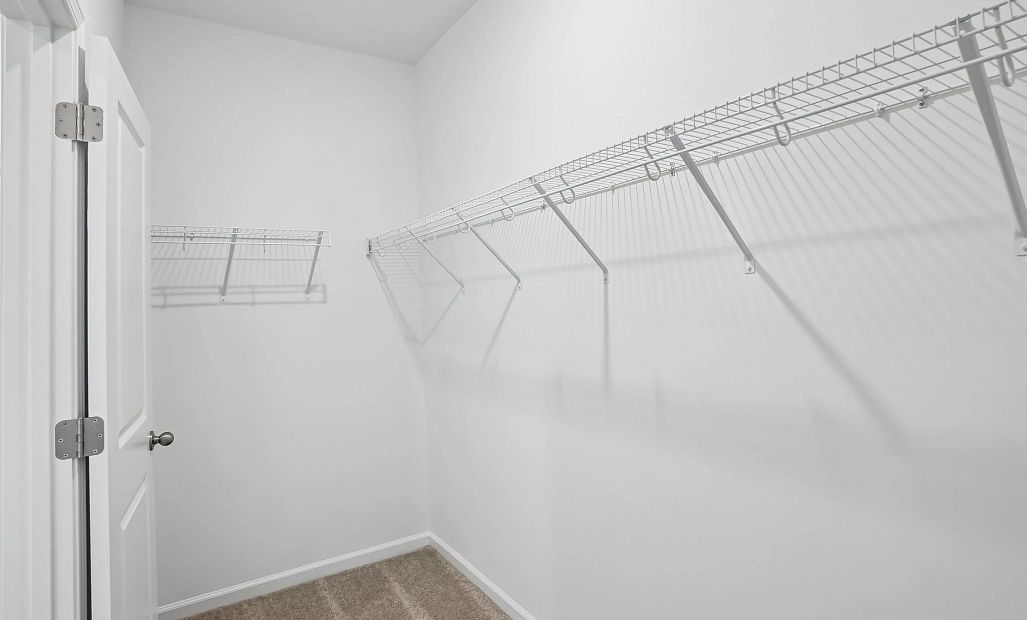 Primary Walk-In featuring the AW Collection® Serene - Open storage with understated design.