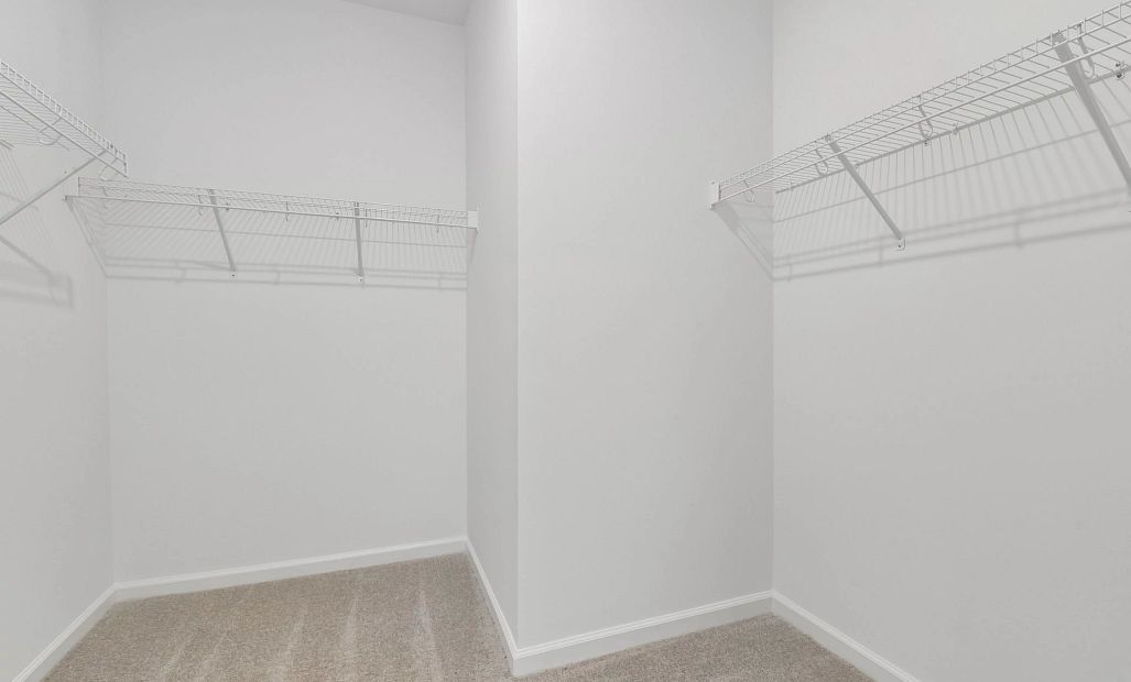 Primary Walk-In featuring the AW Collection® Timeless - Organized luxury with timeless appeal.