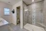 casa en Elevating Your Master Bath With Decorative Tiles por Butler Homes LLC