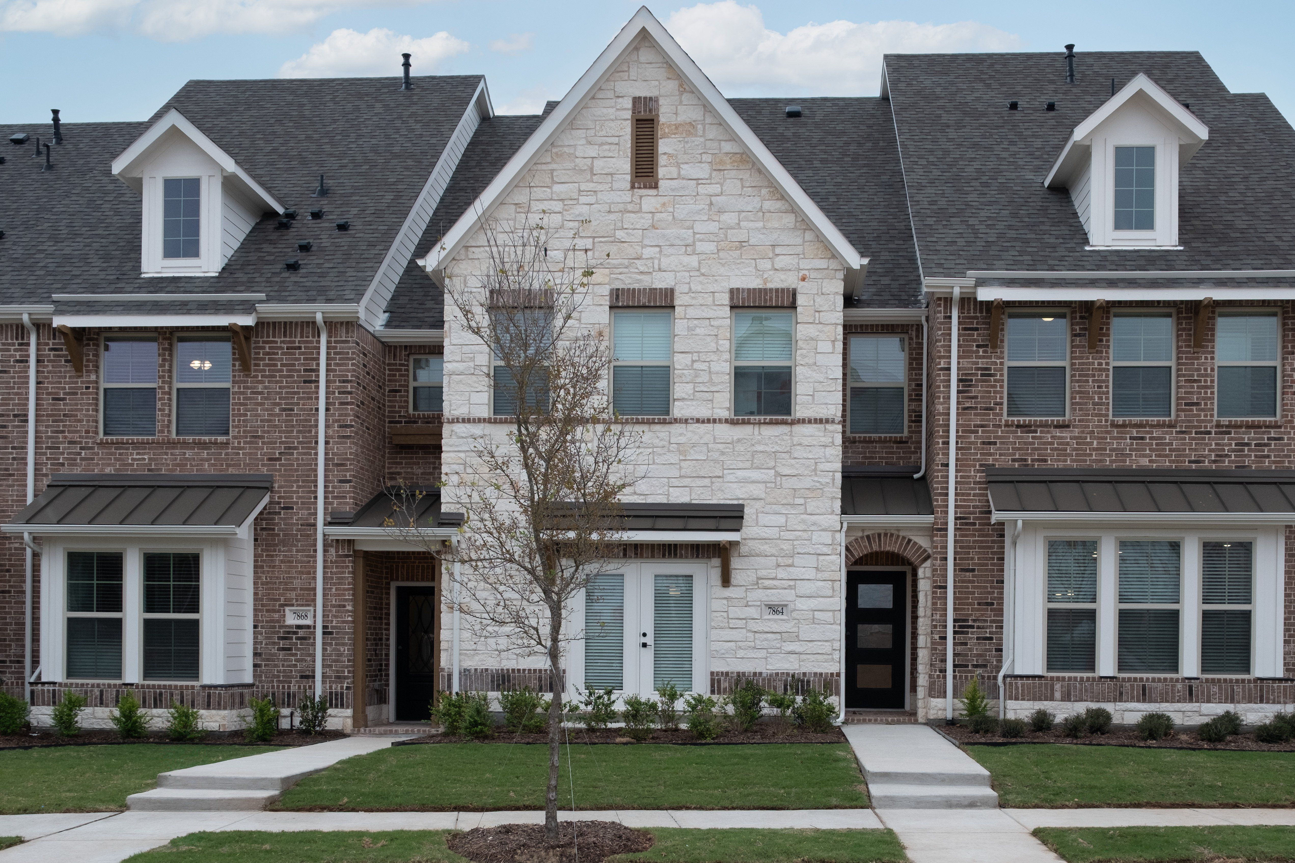exterior of townhome with white stone