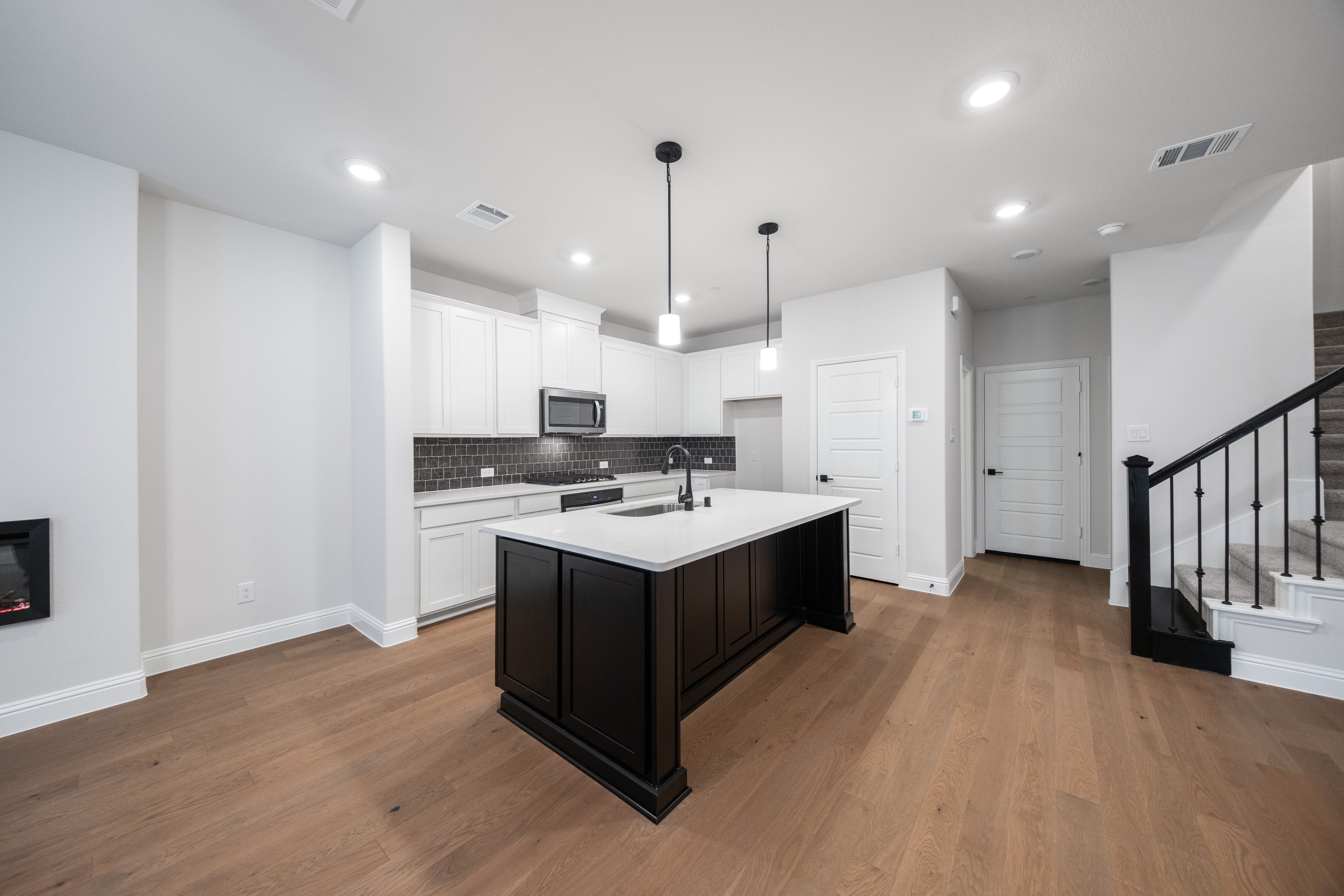 open kitchen with white and black cabinets