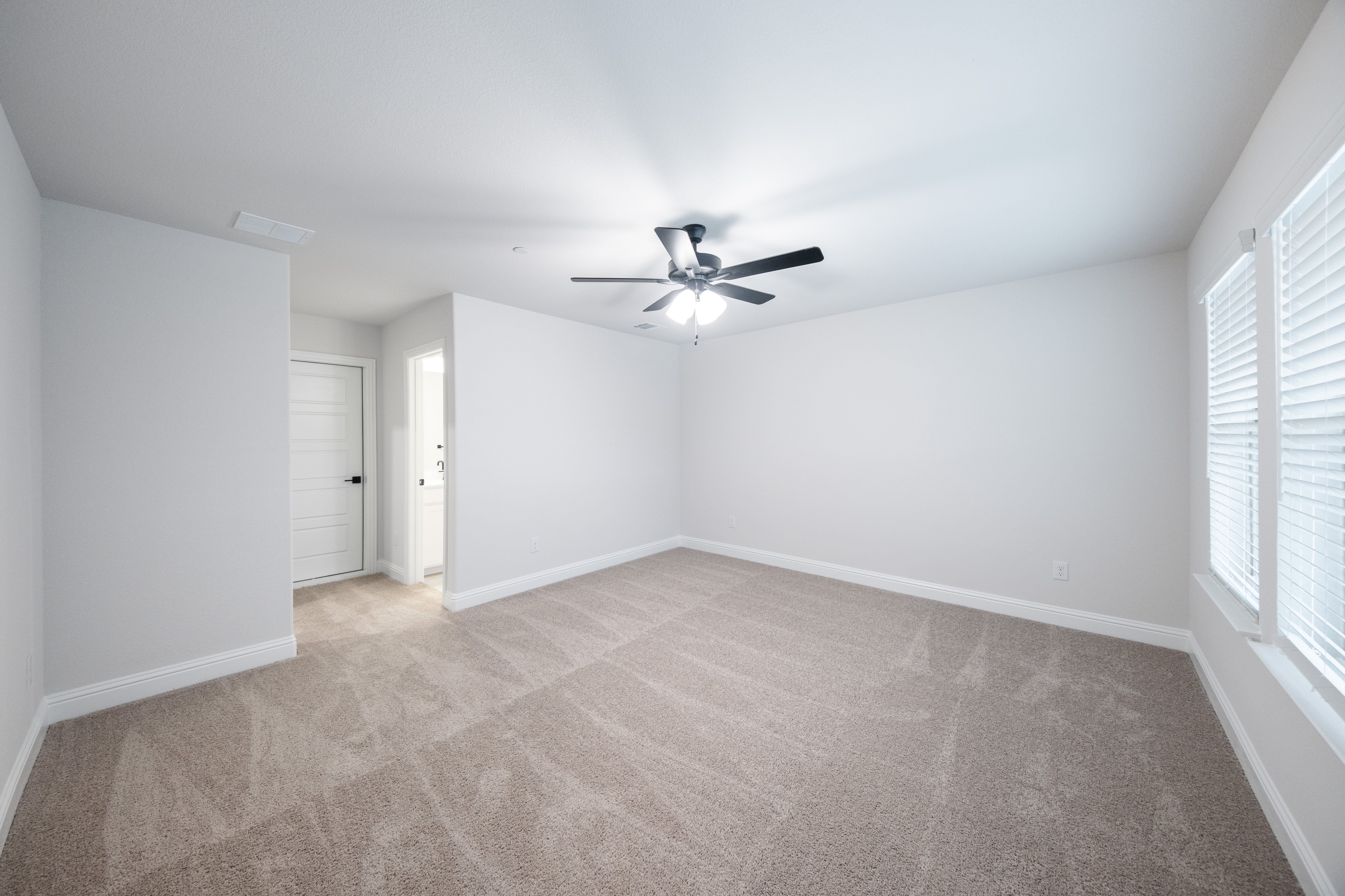 guest bedroom with carpet and window