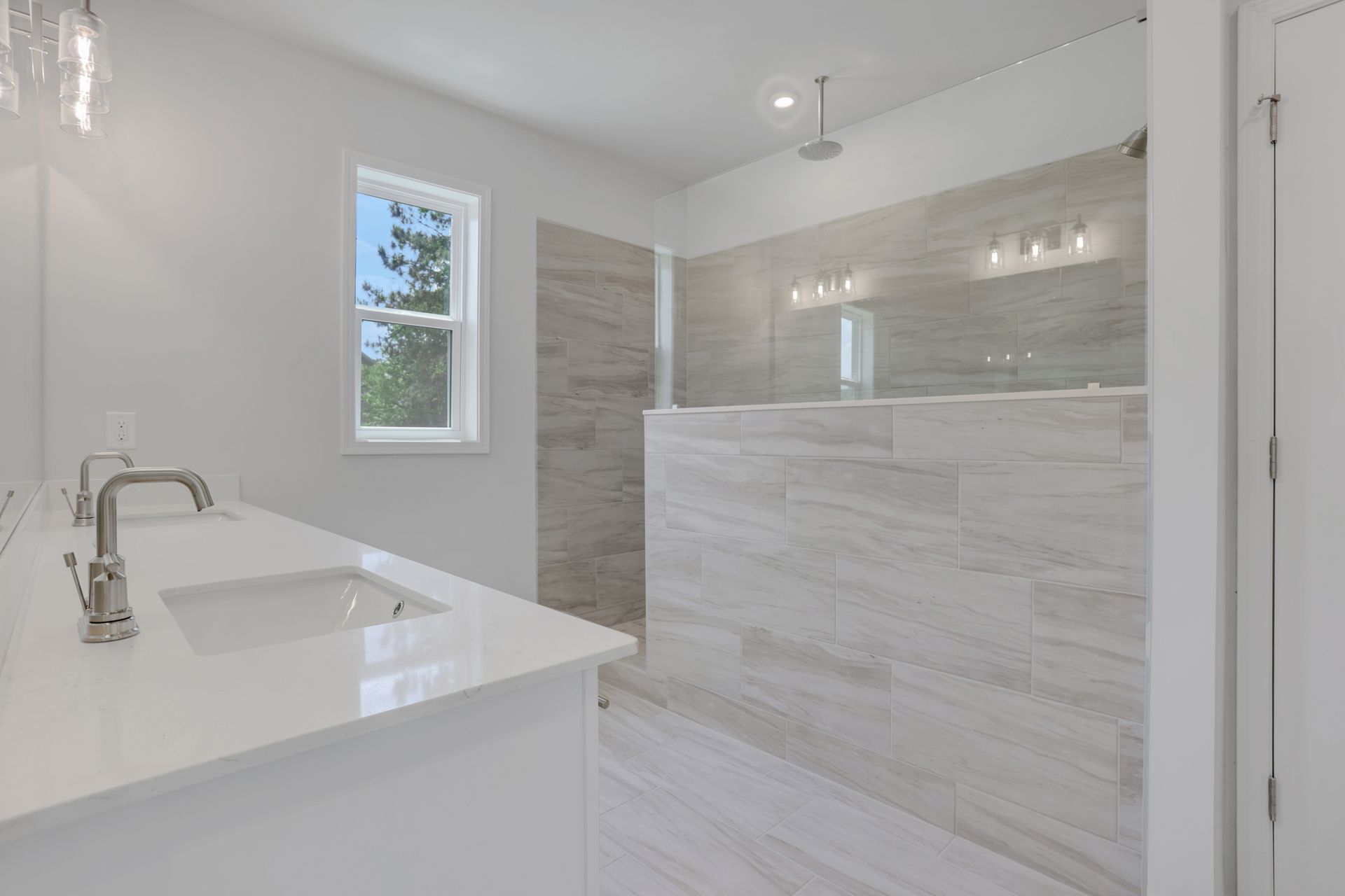 primary bathroom with large walk-in shower and tile flooring