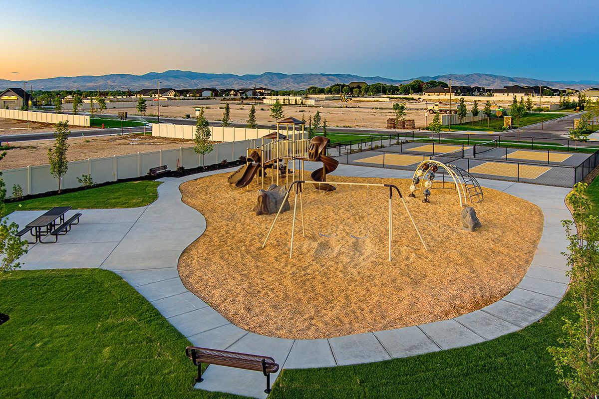 Community Playground featuring swings, climbing gym, slides, picnic tables and more! 
