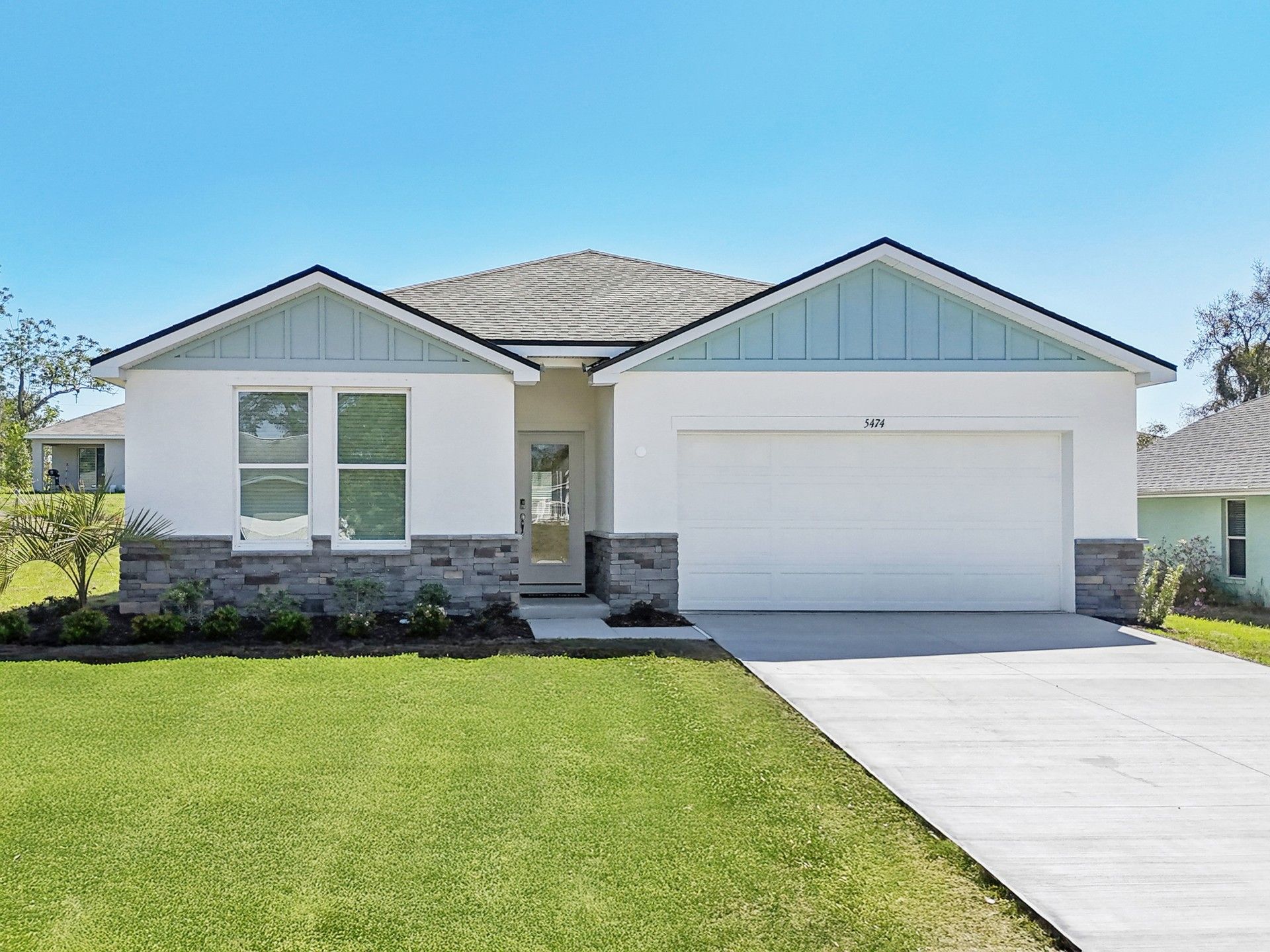 Elegant Spring Hill home features stylish brick accents and a spacious two-car garage.
