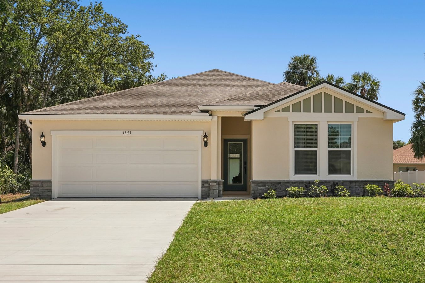 Luxurious North Port home featuring gabled roof and refined stone facade for timeless elegance.
