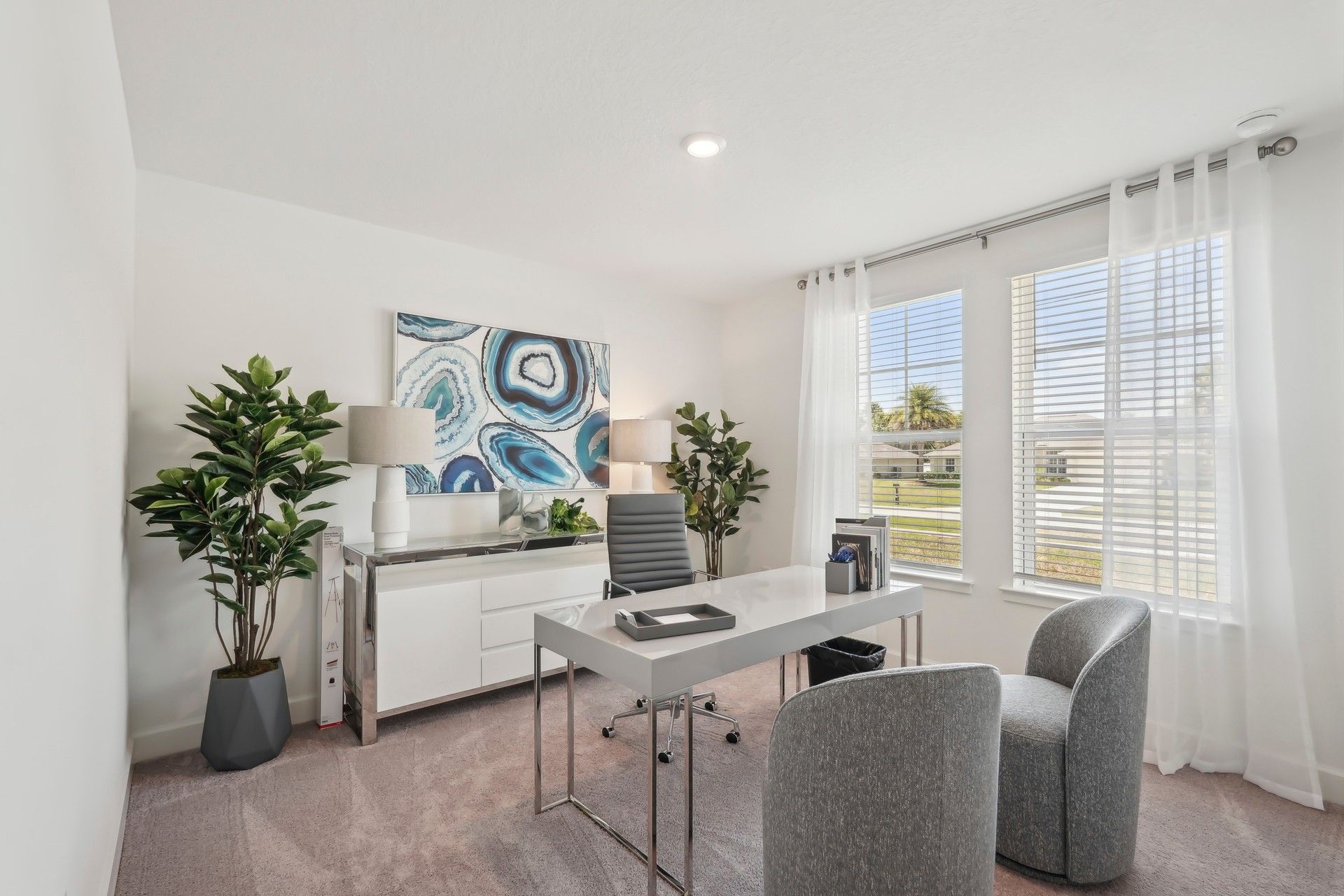 This North Port home office showcases sleek furnishings and expansive windows for natural light.