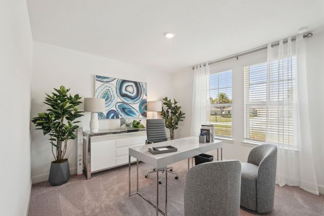 This North Port home office showcases sleek furnishings and expansive windows for natural light.