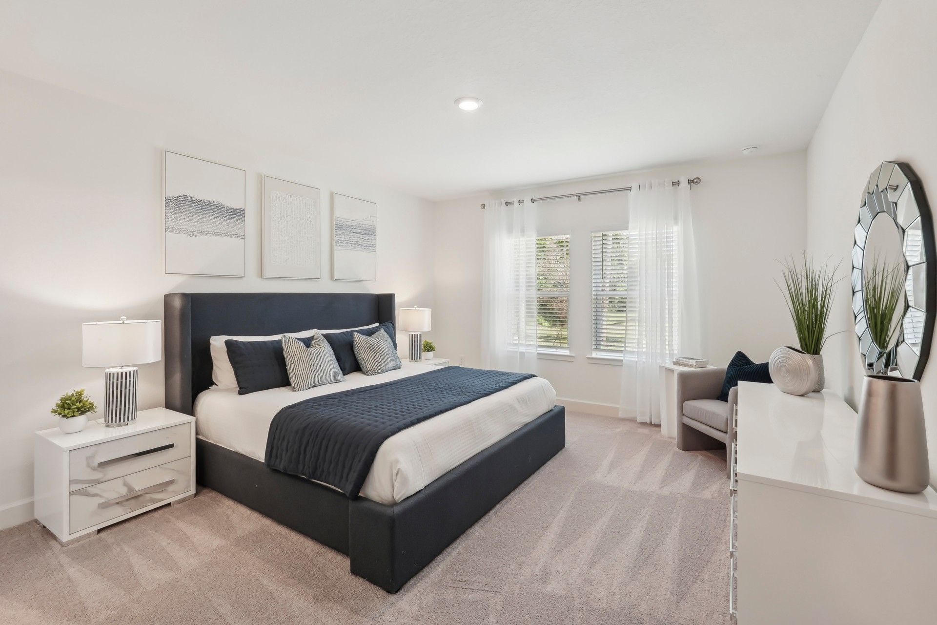 Luxurious North Port bedroom features navy accents, plush carpet, and large window for abundant natural light.