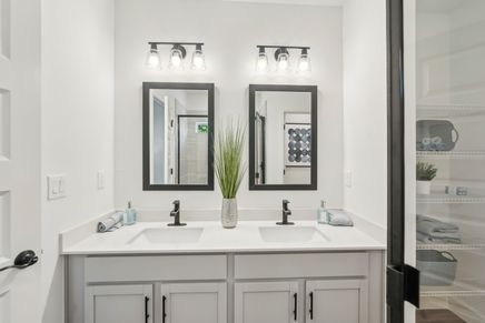 Elegant double vanity with striking black accents highlights luxury in North Port.