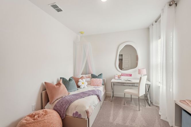 This North Port bedroom blends pastel elegance with a stylish canopy and modern desk.