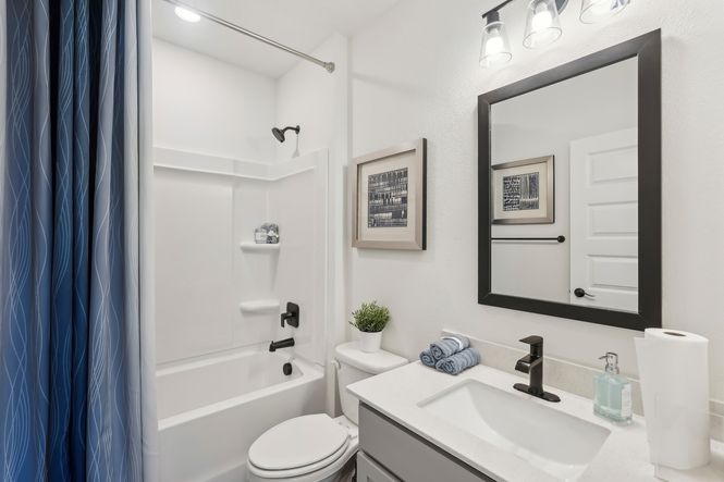 Elegant North Port bathroom features sleek black fixtures and refined accents.
