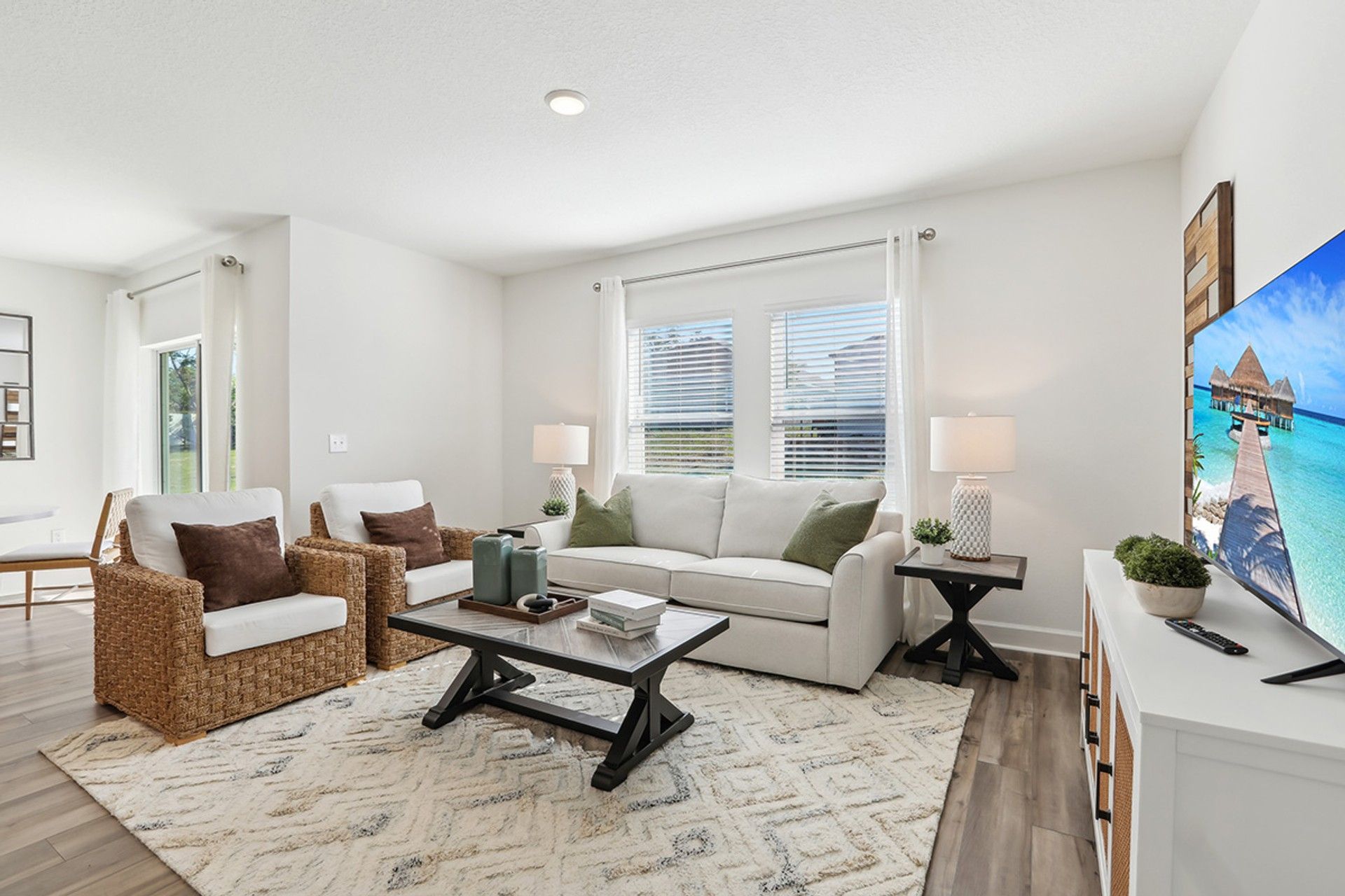 Elegant Spring Hill living area boasts woven chairs and a plush rug, exuding modern sophistication.