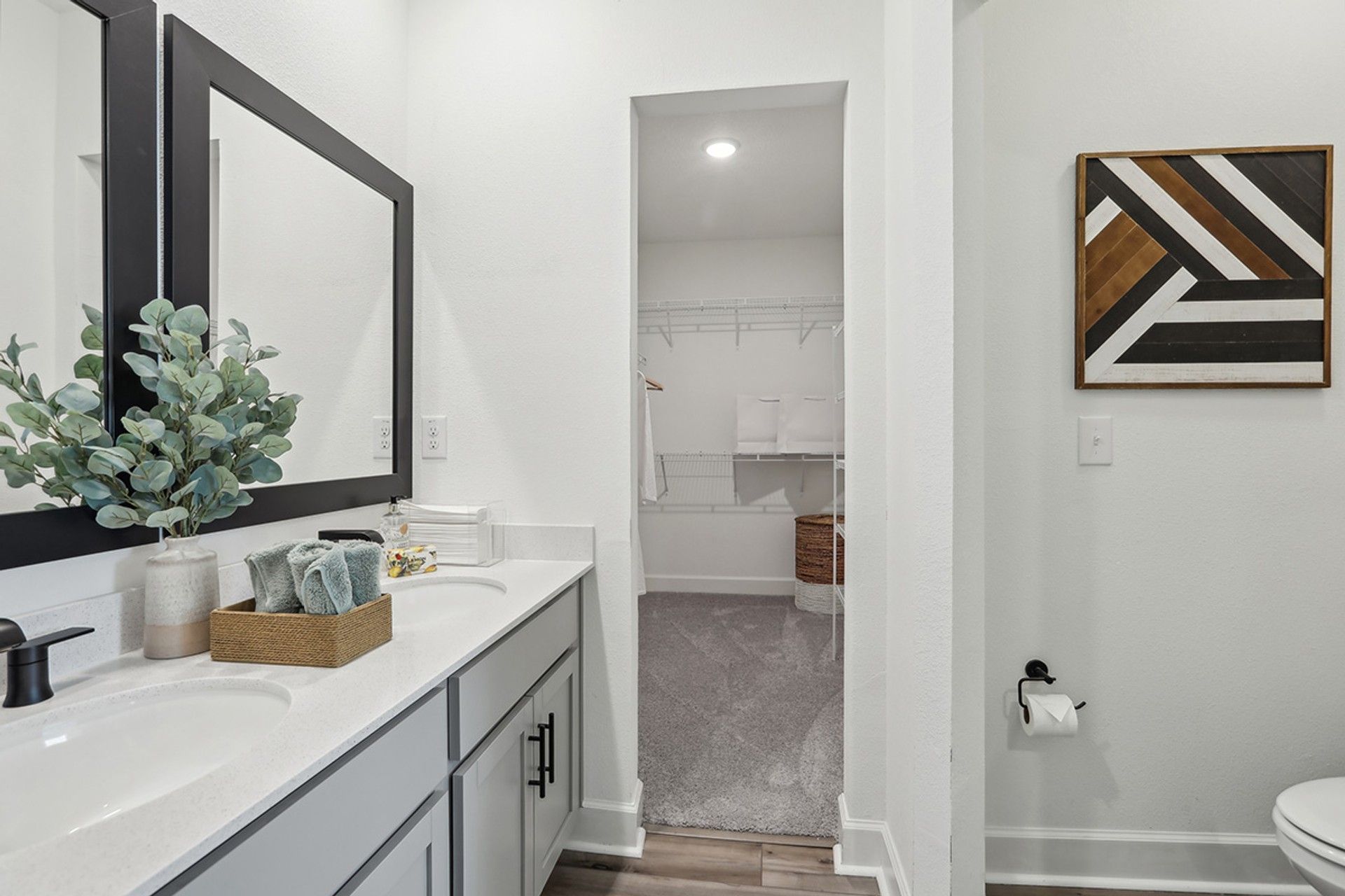 Luxurious Spring Hill bathroom showcases dual sinks and a spacious walk-in closet.
