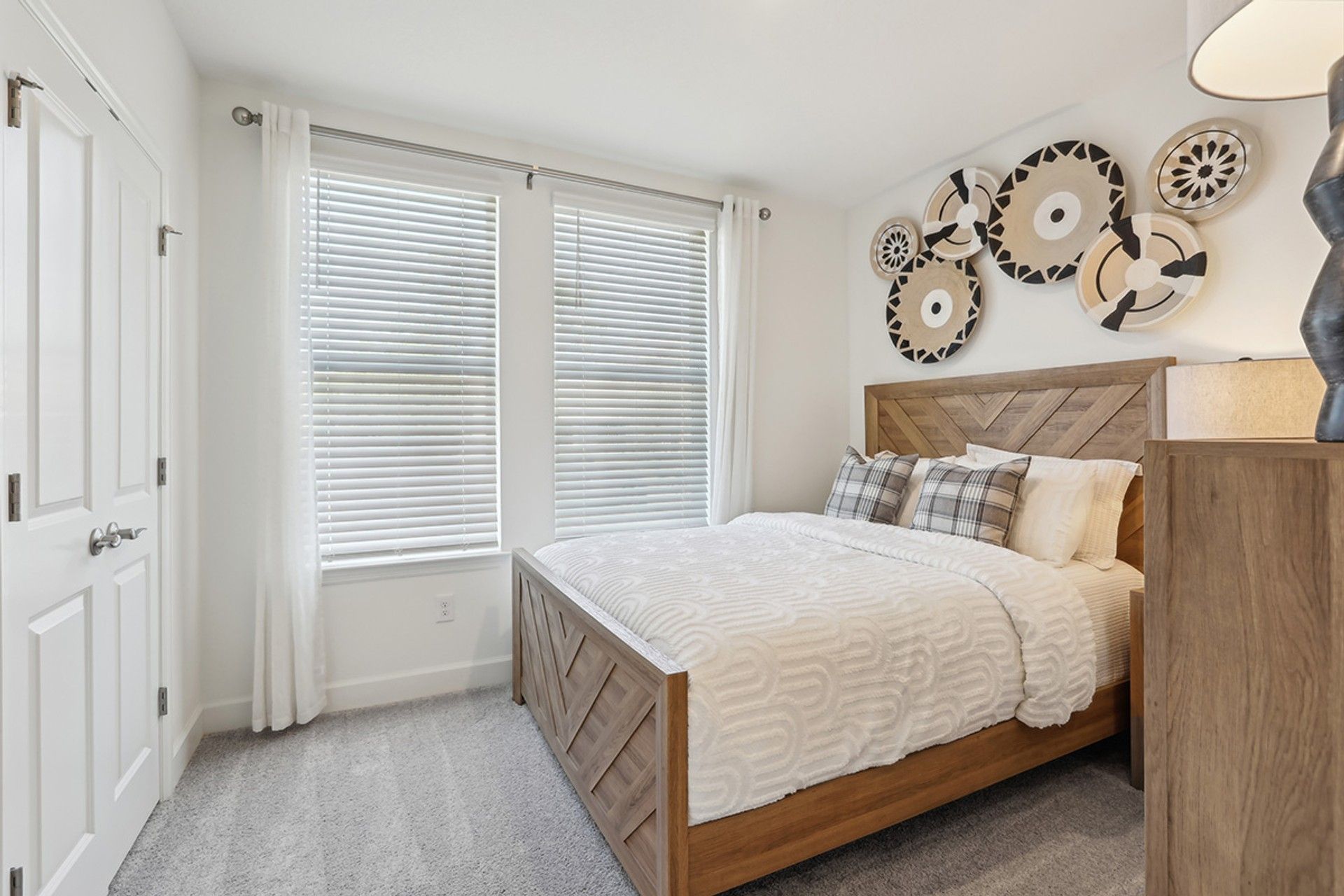 Spring Hill bedroom with custom wood bed and artisan wall décor exudes sophisticated charm.