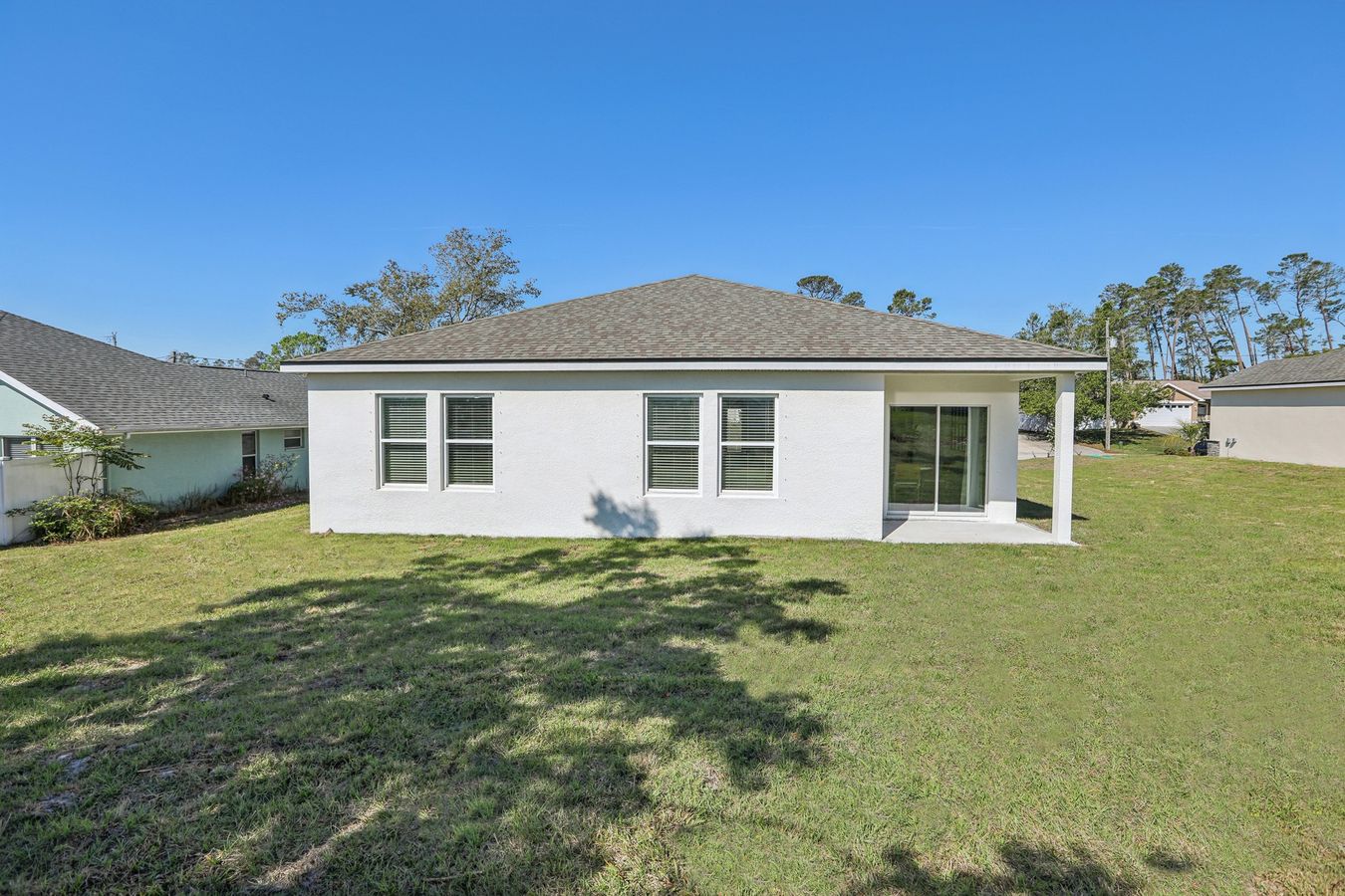 Elegant Spring Hill residence features modern windows and a spacious patio, perfect for serene living.