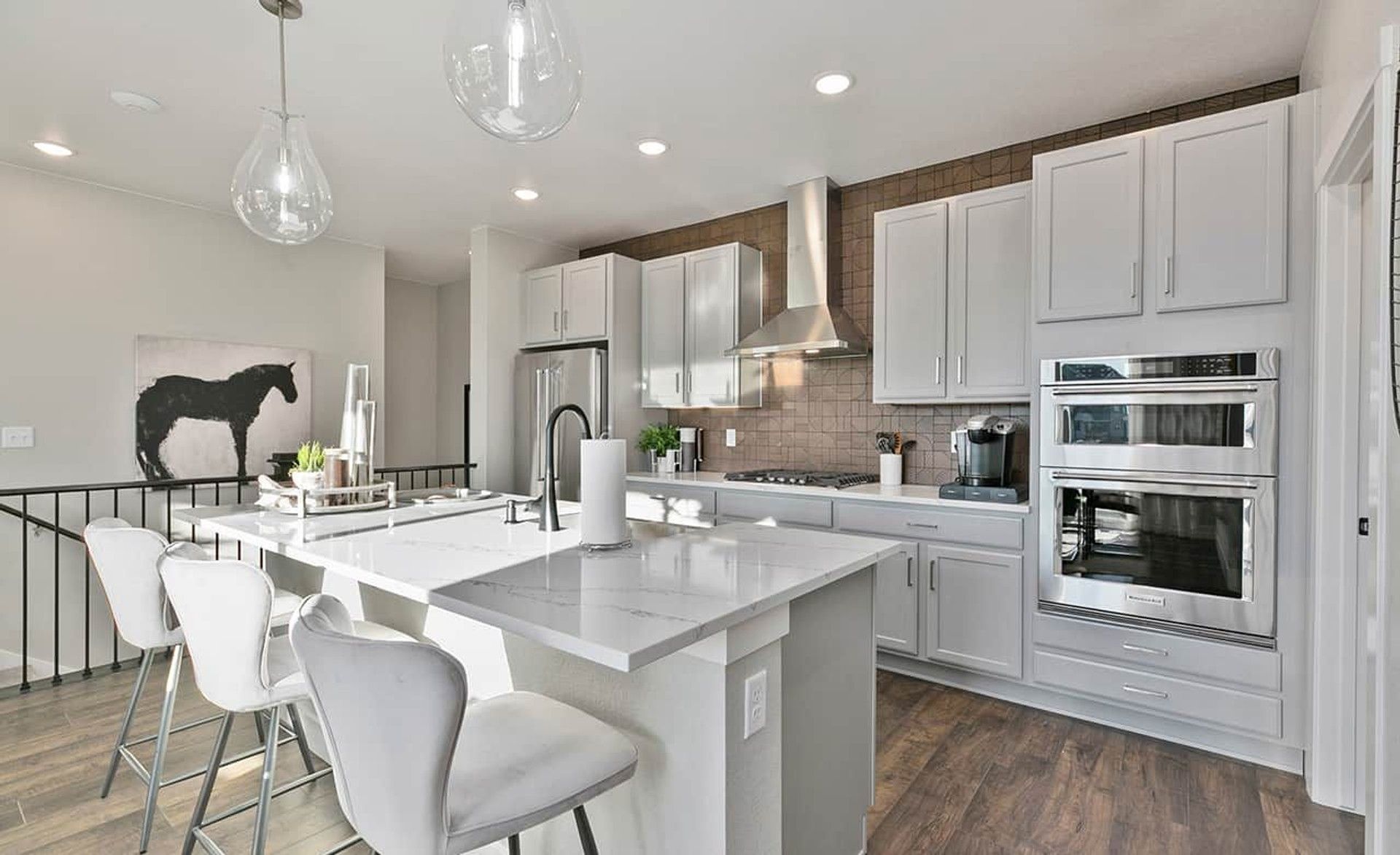 Experience elegance with a marble-topped island and sleek cabinetry in Trailside on Harmony's luxury kitchen.