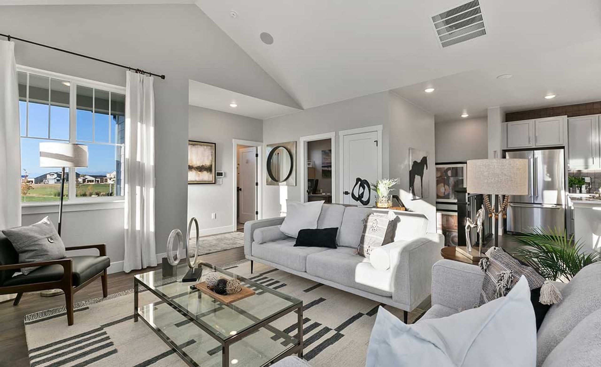 Experience sophisticated luxury with high ceilings and expansive windows in Trailside on Harmony, Colorado.