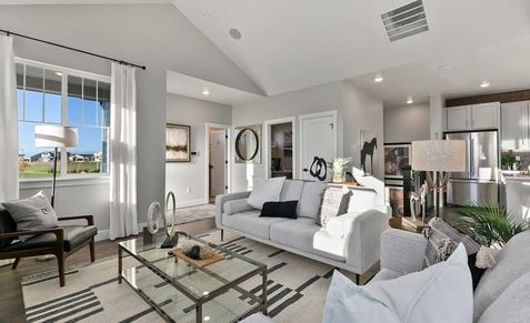 Experience sophisticated luxury with high ceilings and expansive windows in Trailside on Harmony, Colorado.