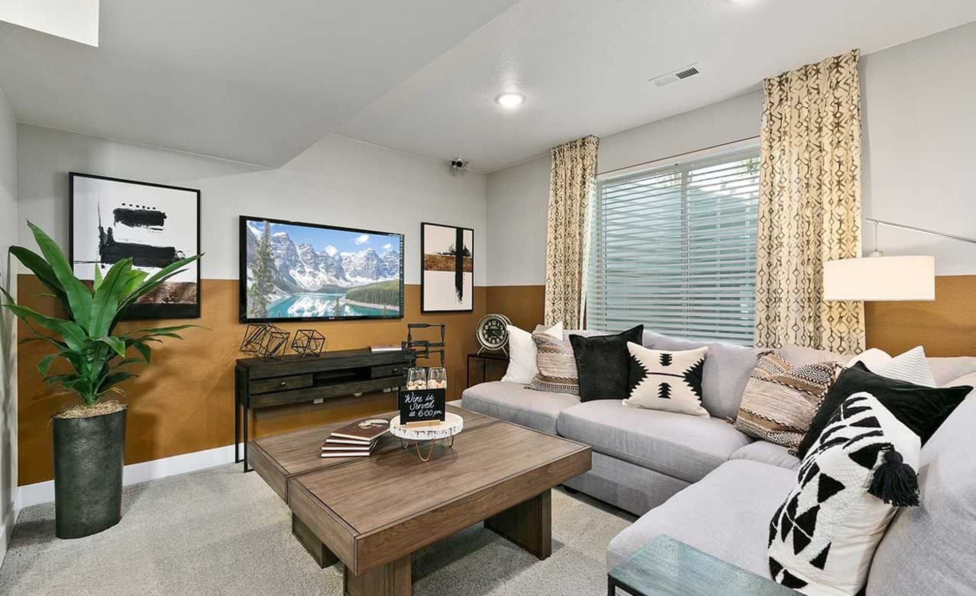 Luxurious Nordic elements enhance this Trailside on Harmony living room with sleek sectional and geometric decor.