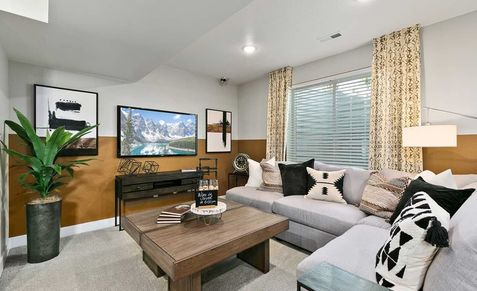 Luxurious Nordic elements enhance this Trailside on Harmony living room with sleek sectional and geometric decor.