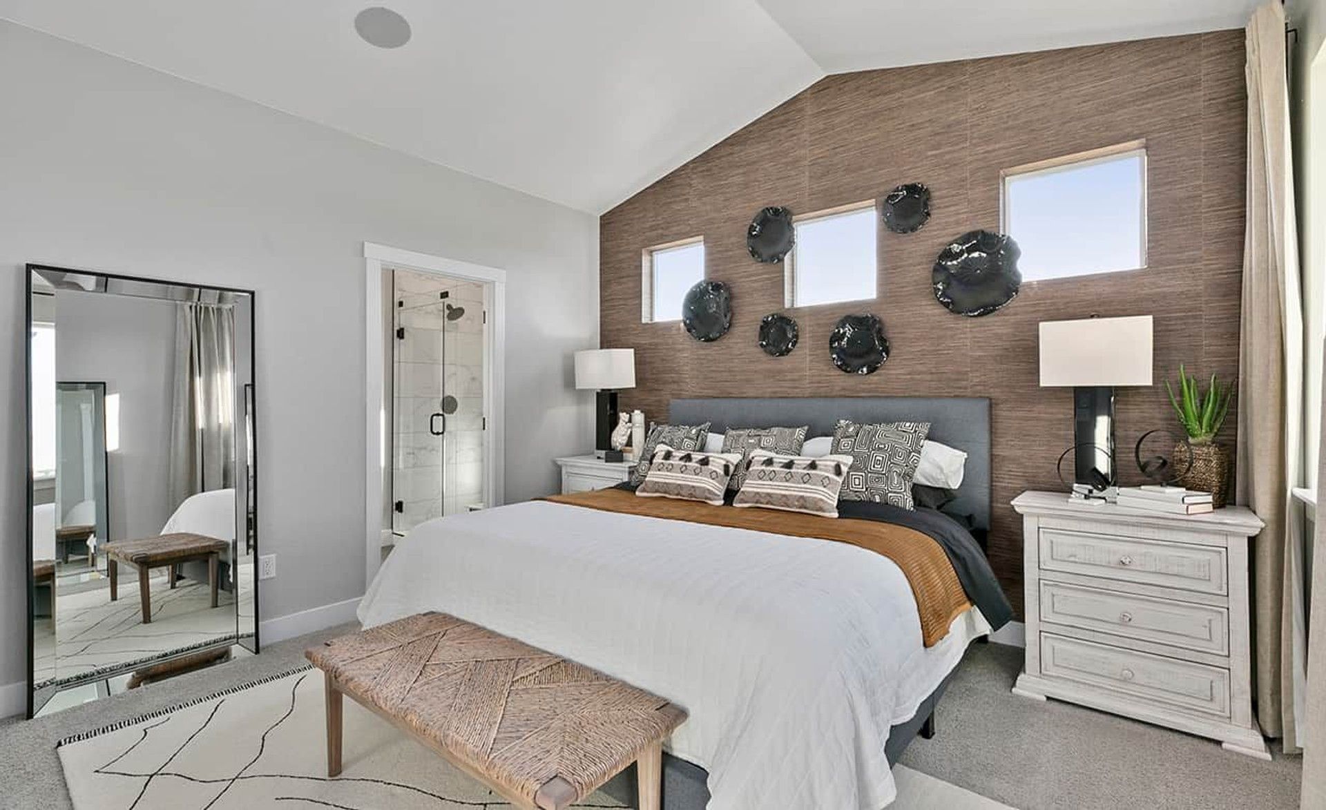 Revel in modern elegance with a textured accent wall and designer decor in Trailside on Harmony.