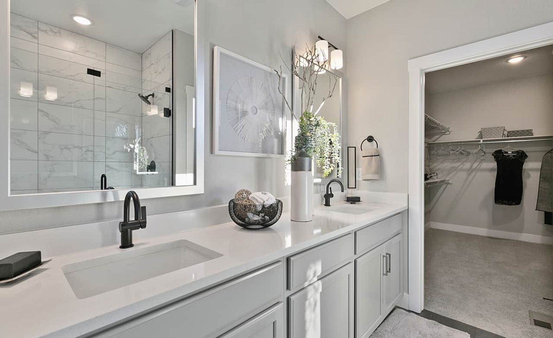 Elegant marble shower and custom cabinetry highlight this opulent Trailside on Harmony bathroom.