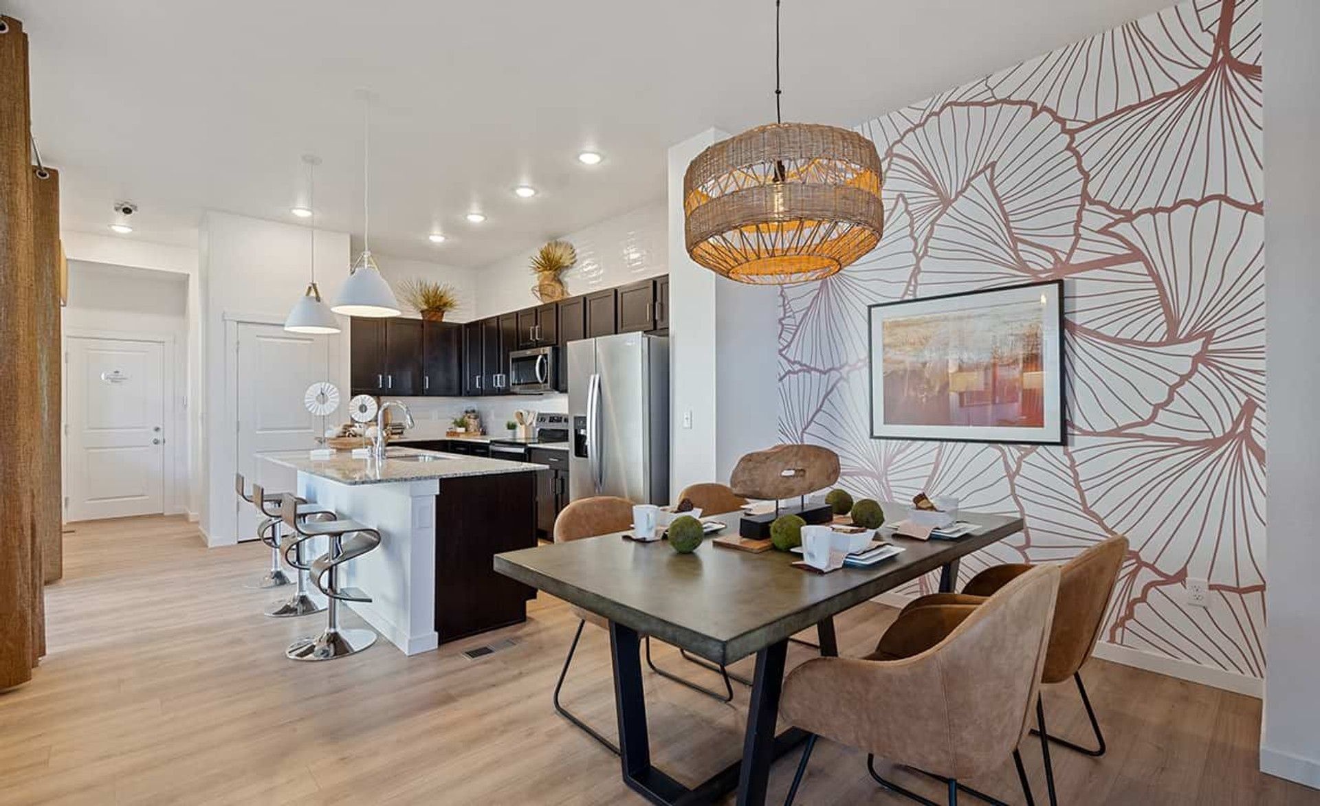 Experience refined elegance with a floral accent wall and chic lighting in Trailside on Harmony.