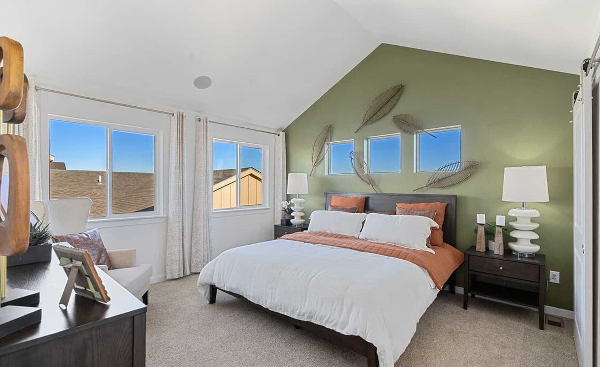 Revel in vaulted ceilings and contemporary design in Trailside on Harmony's exquisitely appointed bedroom.