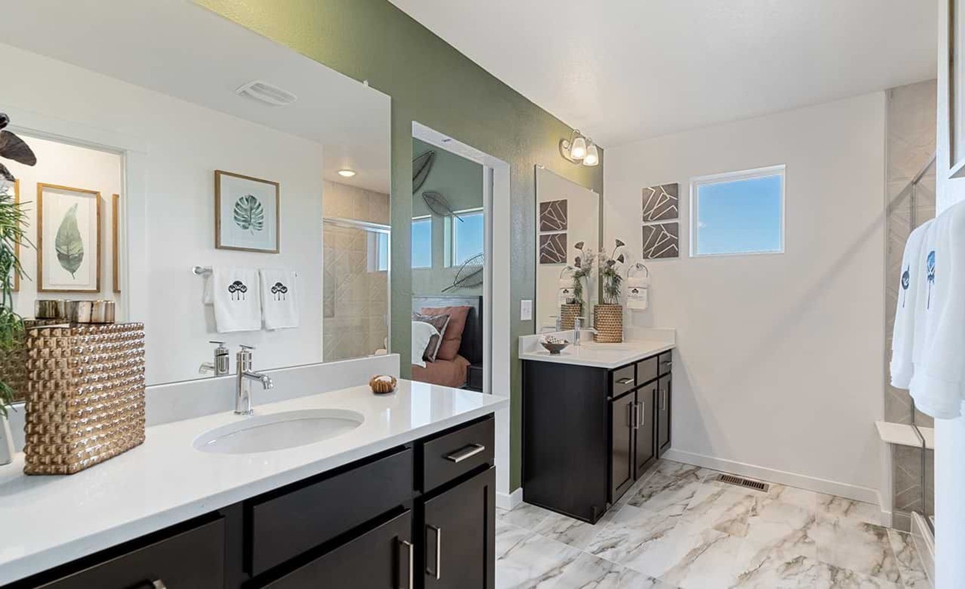 Exquisite double vanity, sleek dark wood cabinets, and elegant marble flooring in Trailside on Harmony.