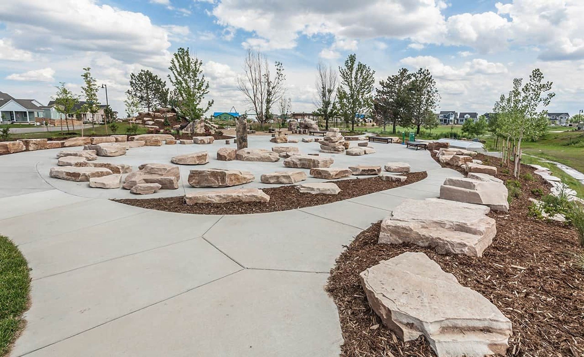 Discover natural stone seating and artfully curved pathways in Trailside on Harmony, Colorado.