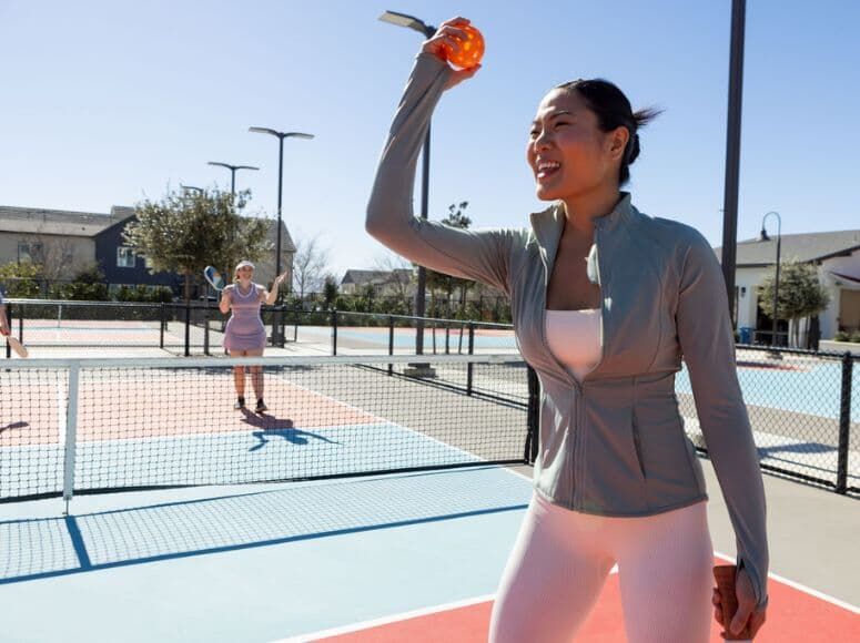 Friends playing pickleball at the Canvas Park amenity