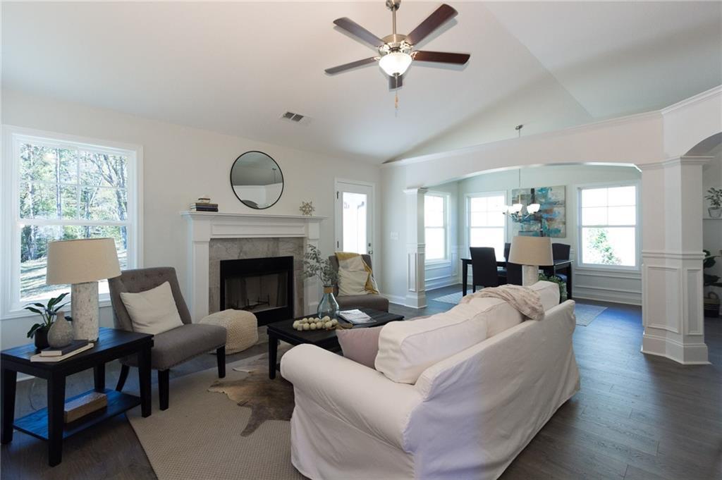 Great Room view from front door.  Fireplace in Great Room with Colonial Mantle with Tile.  Vaulted Textured California Ceilings.  LVP Flooring, Upgraded Trim Package.  