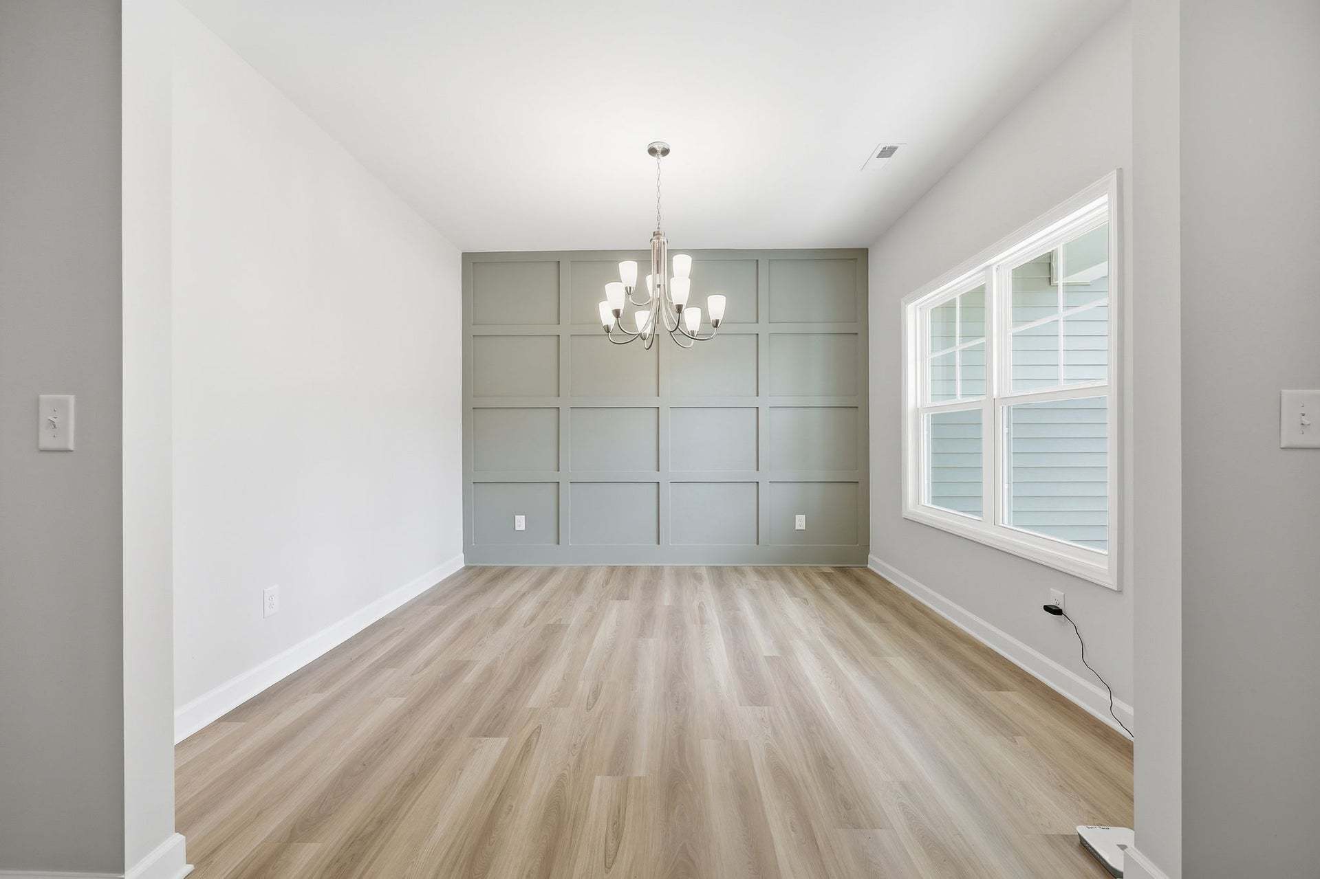 Formal Dining Room With Traditional Panel Accent Wall