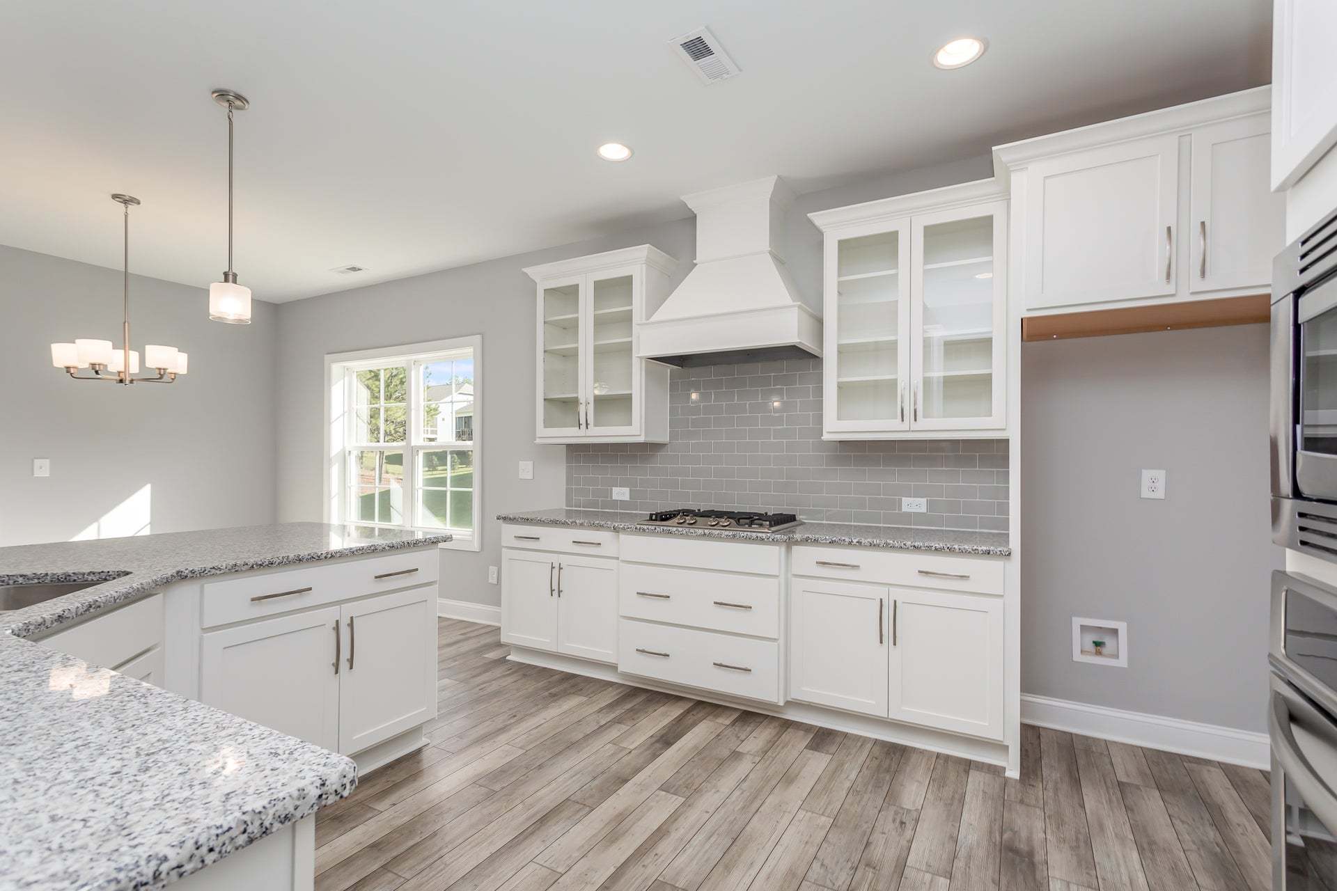 Gourmet kitchen with vent hood and glass cabinet options