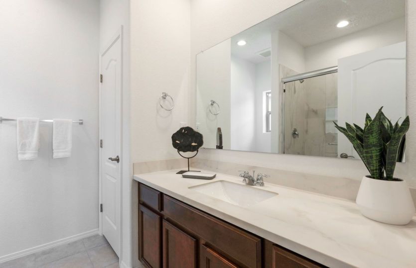 Porcelain countertops with backsplash in the owner's suite bath