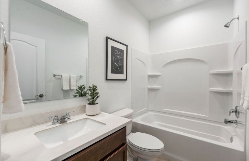 Bathroom 2 finished with porcelain countertop and a shower/tub combination