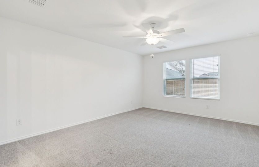 Owner's suite with large windows and private bath